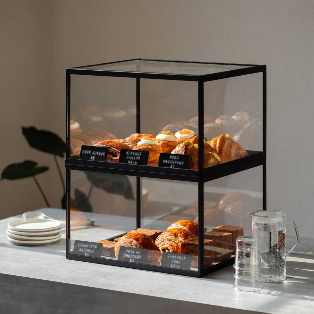 Two stacked bakery display cabinets demonstrating multiple tiers showcasing fresh pastries