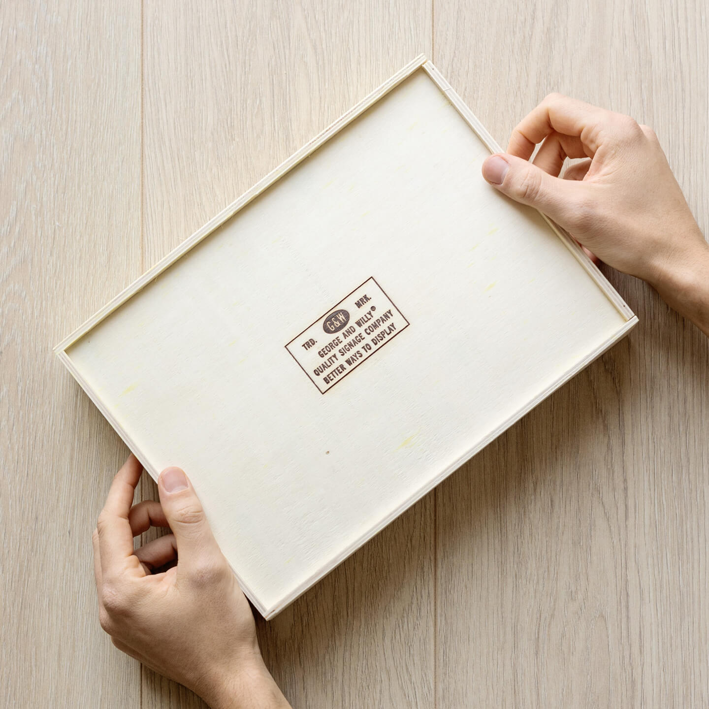 two hands holding the box that card counter signs come in