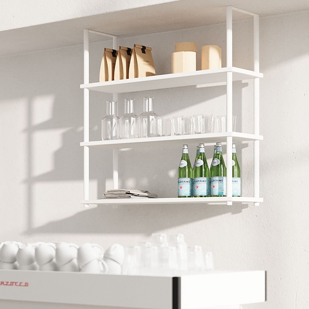 white ceiling mounted shelves displaying water, cups, and coffee behind a countertop