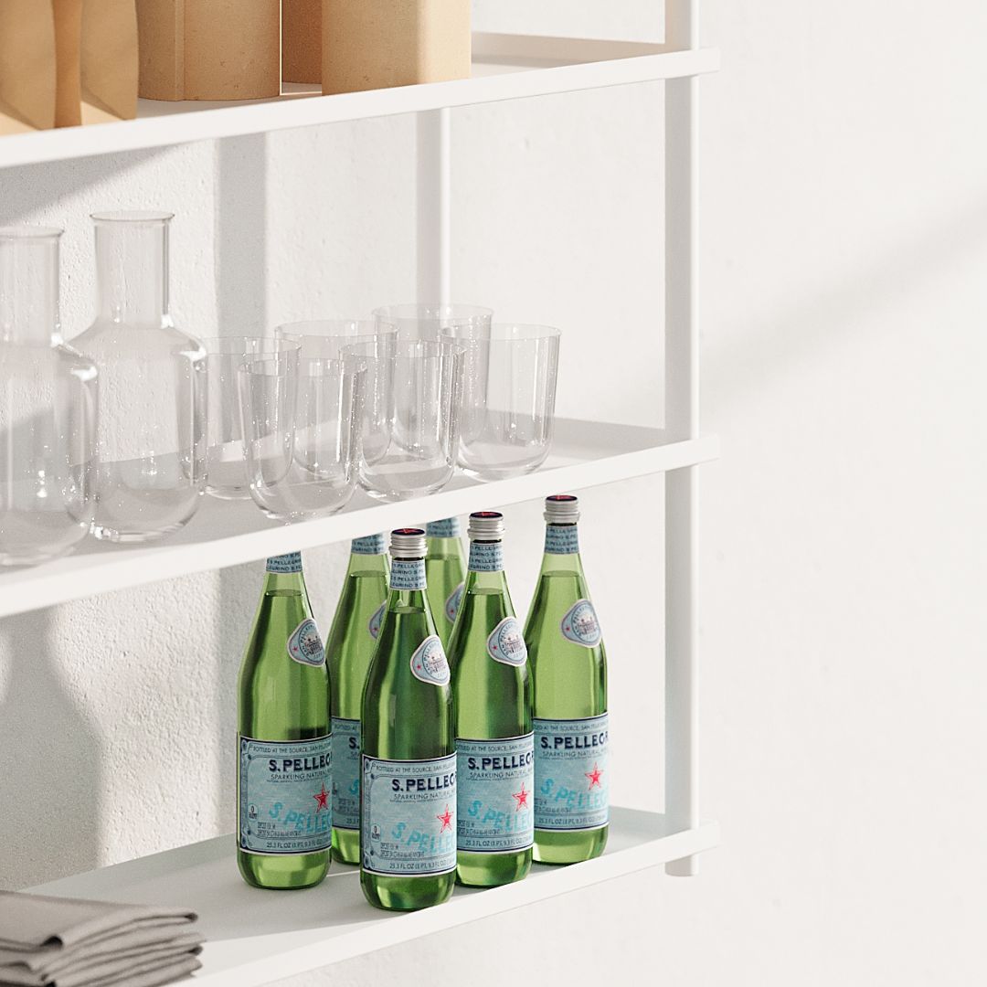 close up of white ceiling mounted shelves displaying san pellegrino water bottles