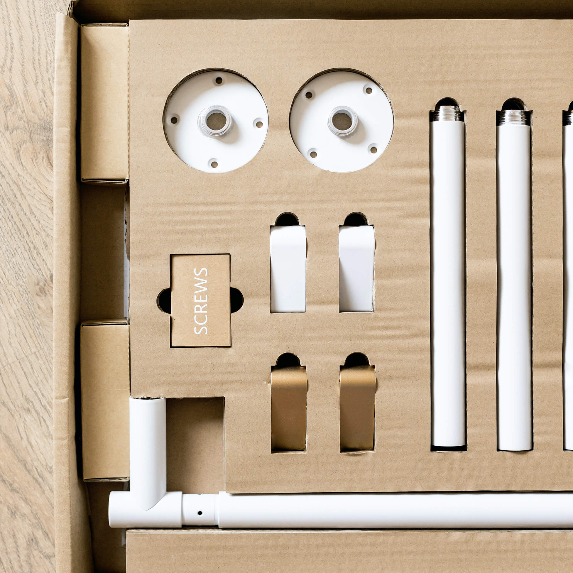 close up detail of the unassembled contents of the packaging of the handing menu board