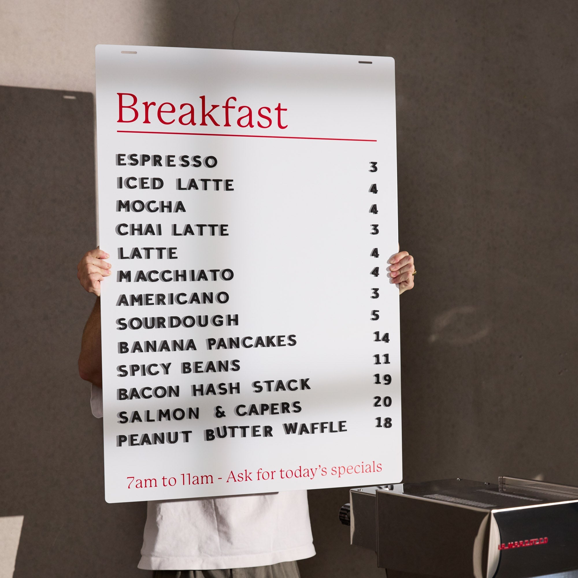two hands holding up the face panel of a white hanging menu board