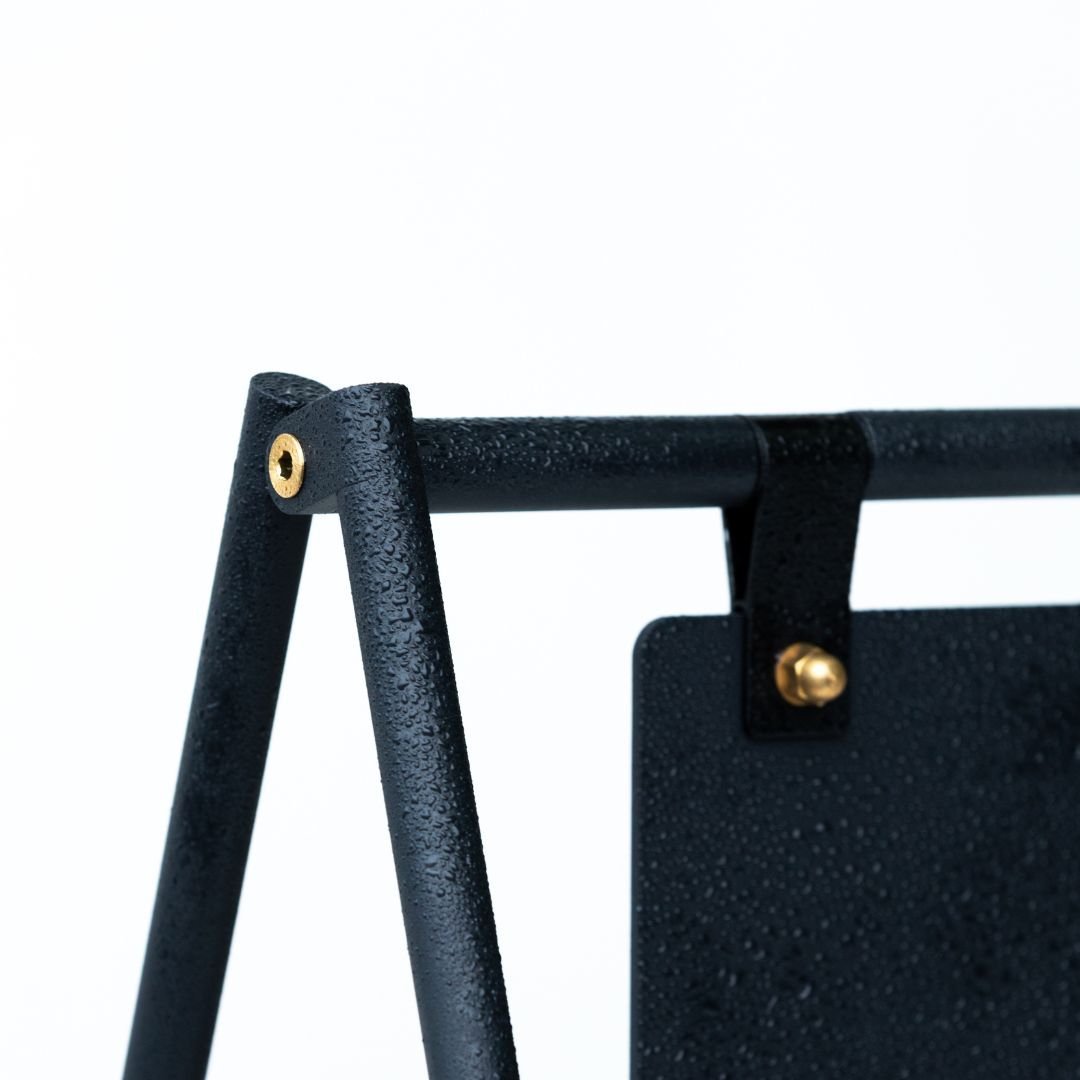 close up of the black sidewalk sign showing bolts and joinery