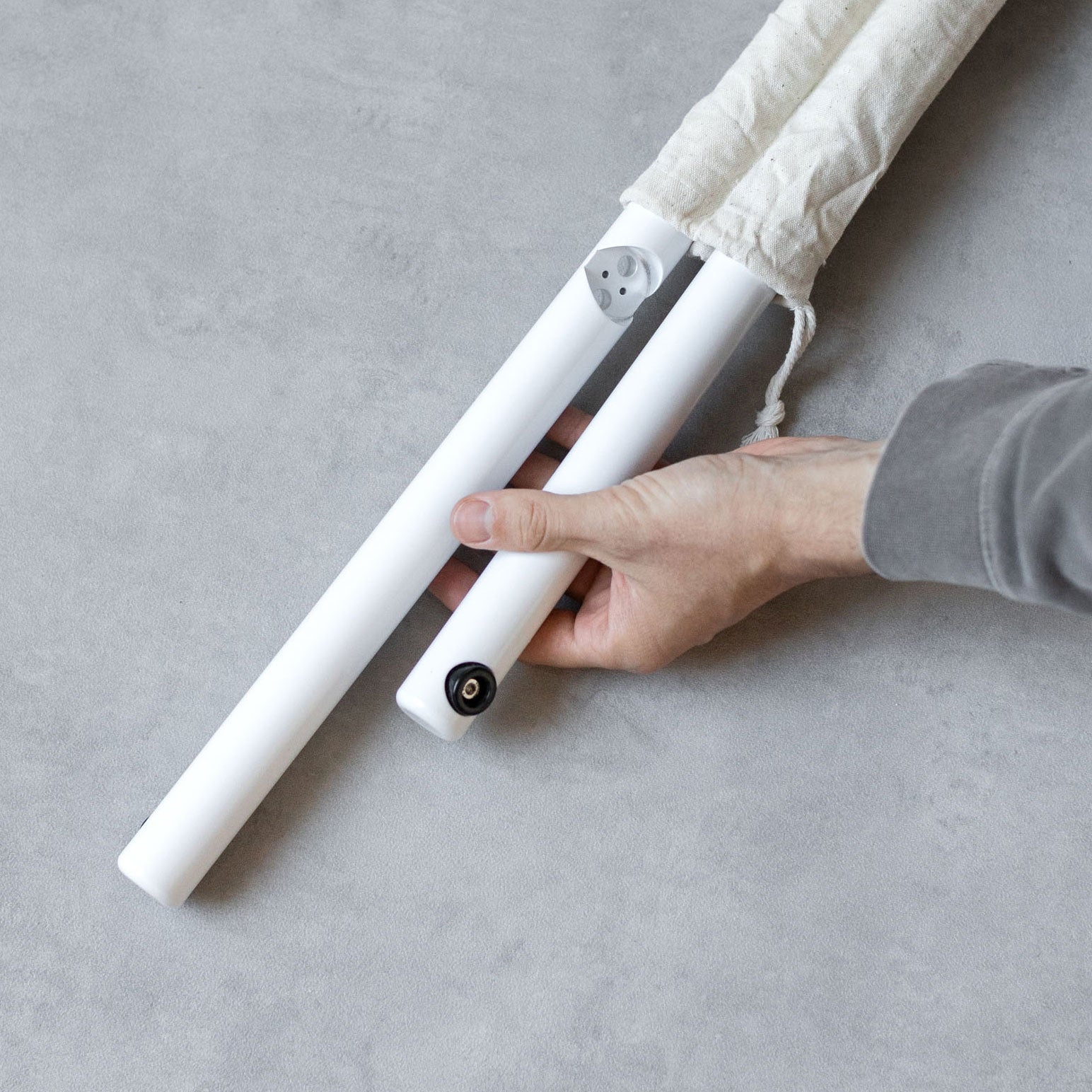 photo of hand holding the unassembled poster sidewalk sign rails to show detail