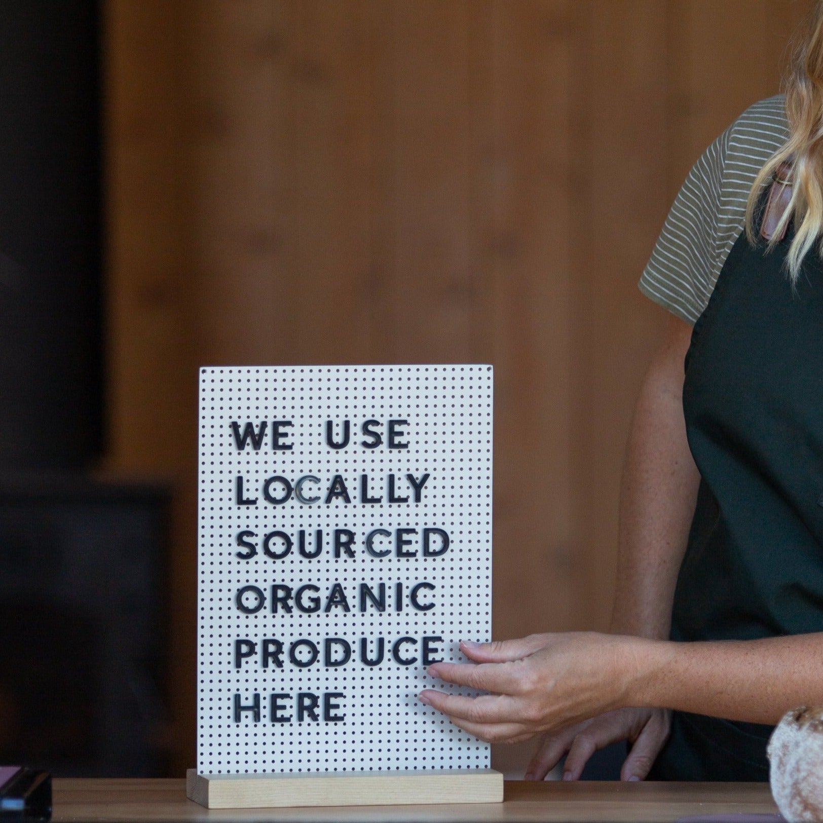 hand adjusting the letters of the mini specials board display