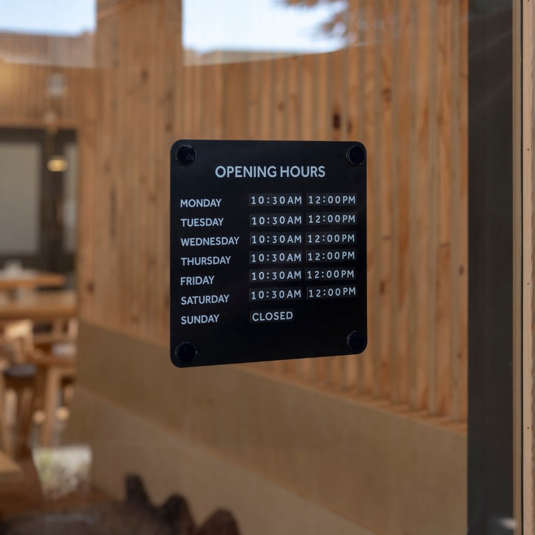 Black steel open office hours sign for window displaying business hours of operation