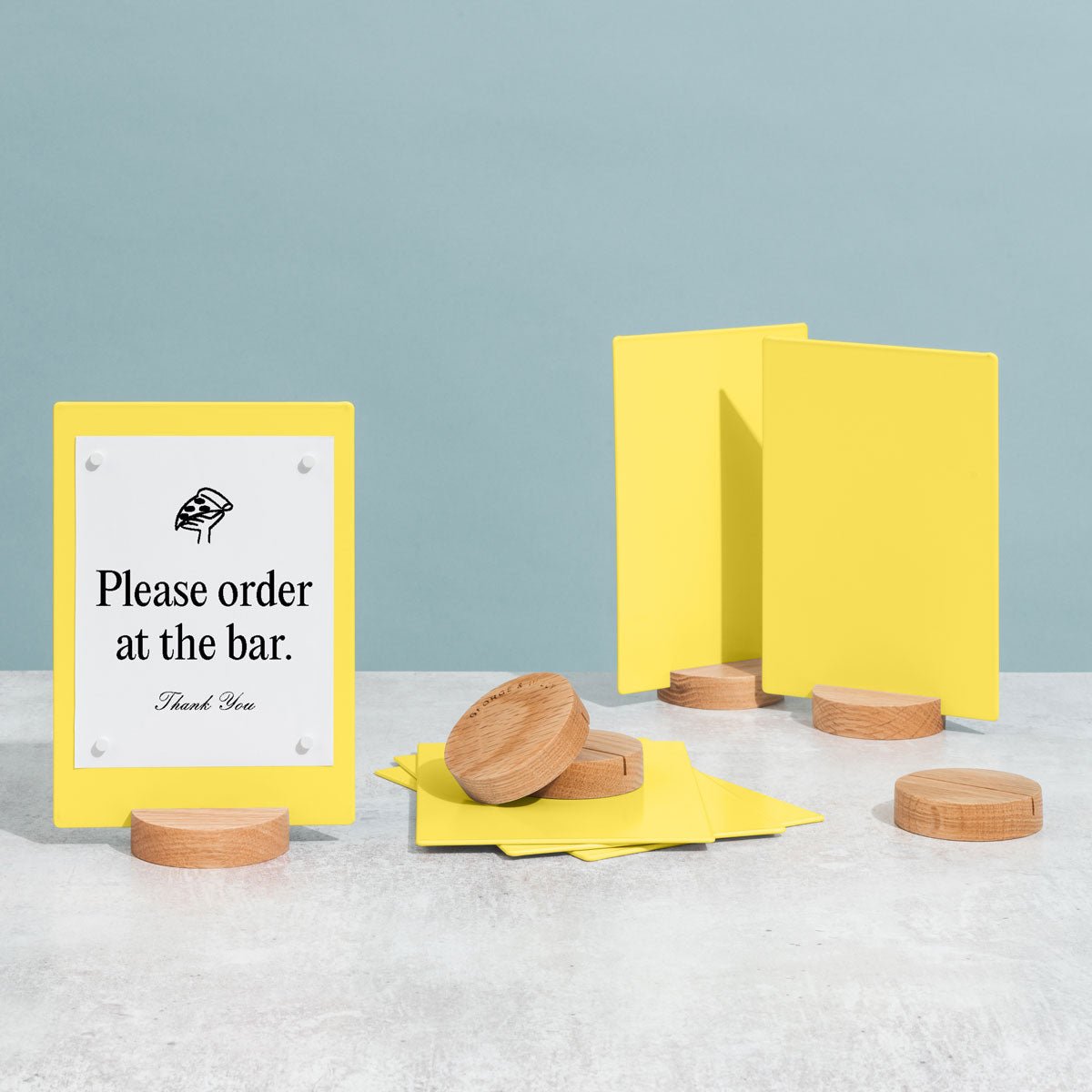 three table talkers in yellow and extra bases on a tabletop