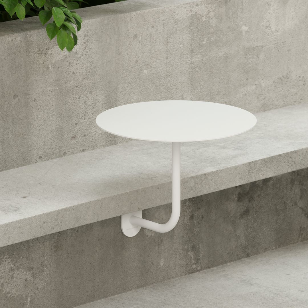 bistro style cafe table attached to bench seat outside restaurant