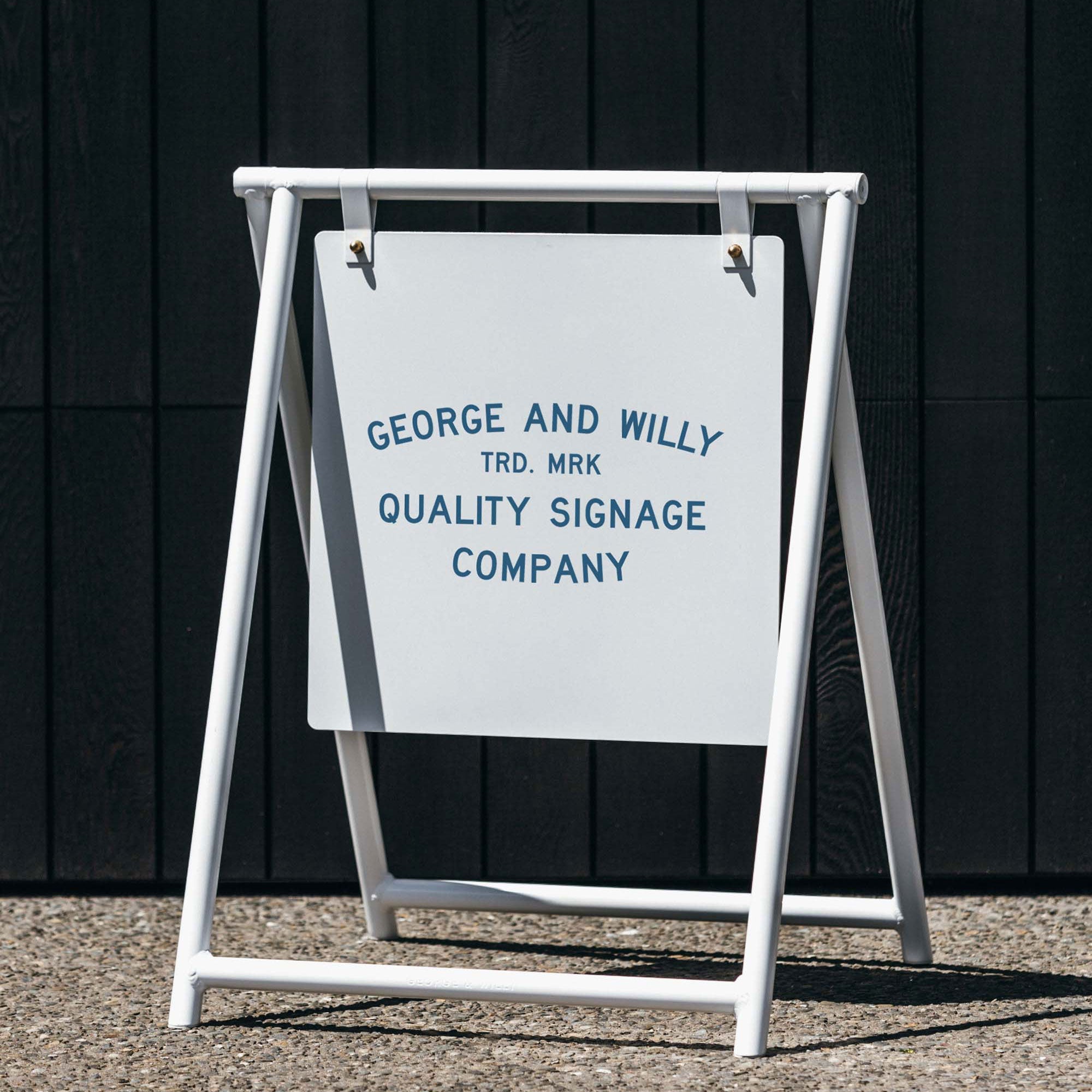 Black A Frame sandwich board sign outside storefront, showing business logo