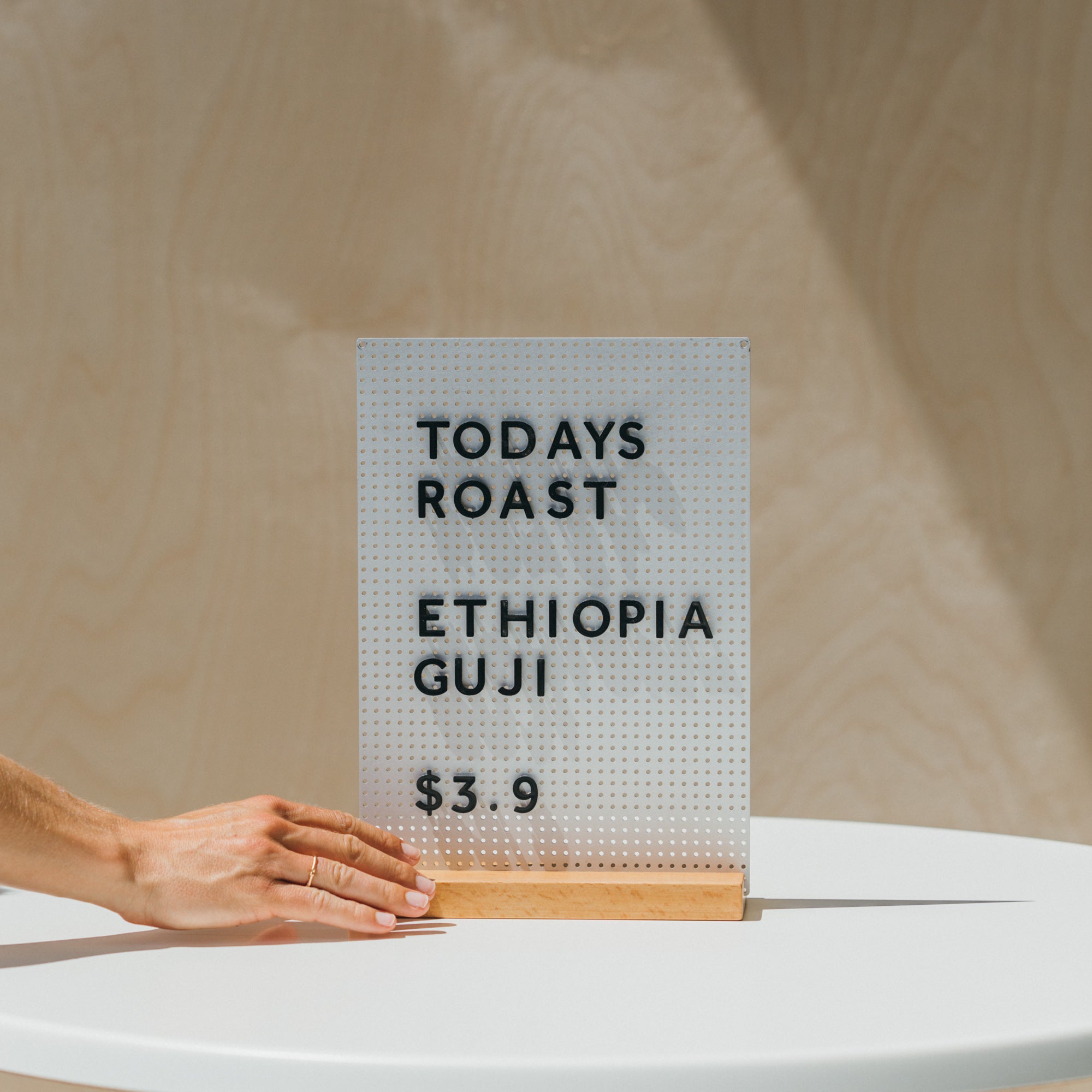 hand holding the mini peg letter board as a specials menu displaying daily specials