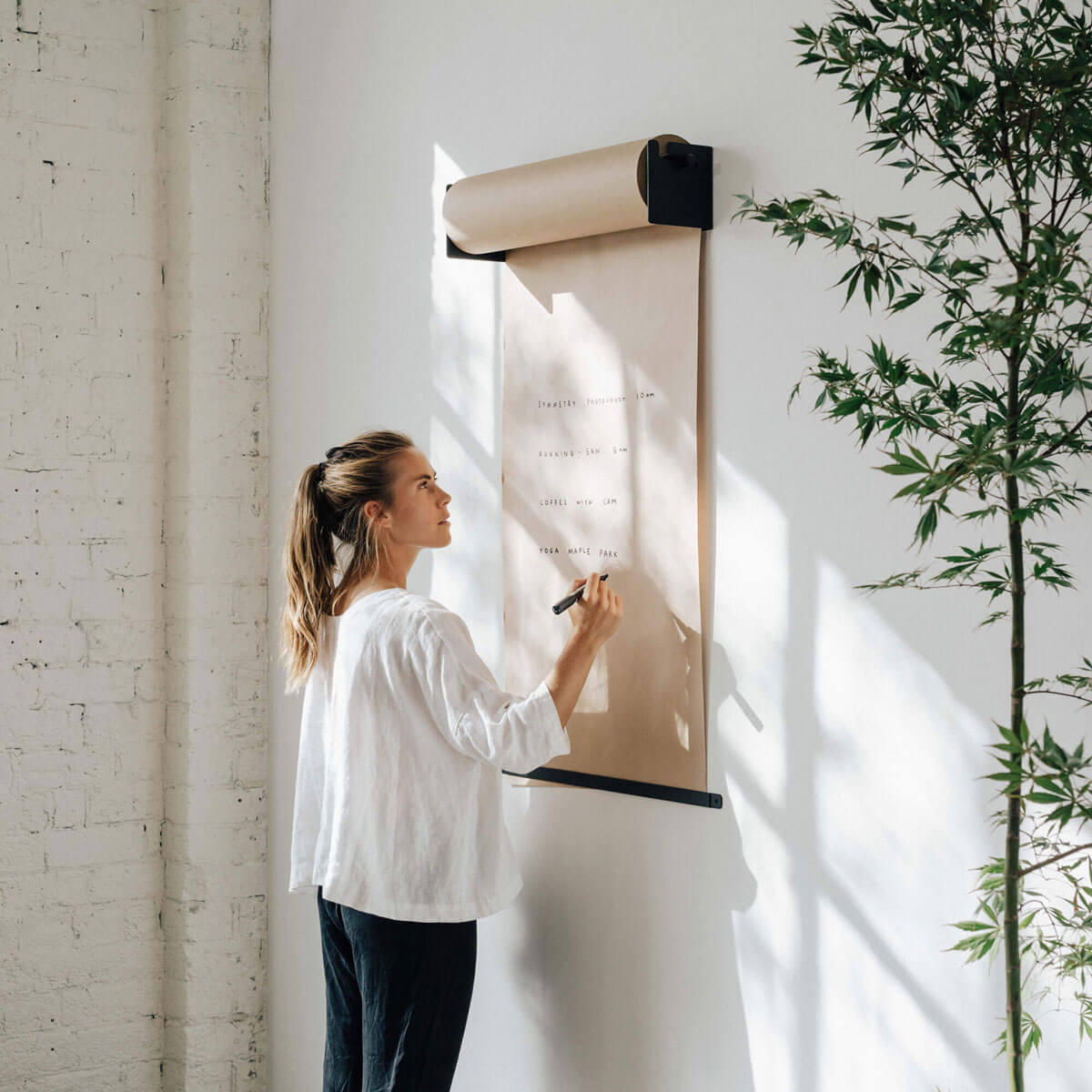 girl writing on the studio roller paper