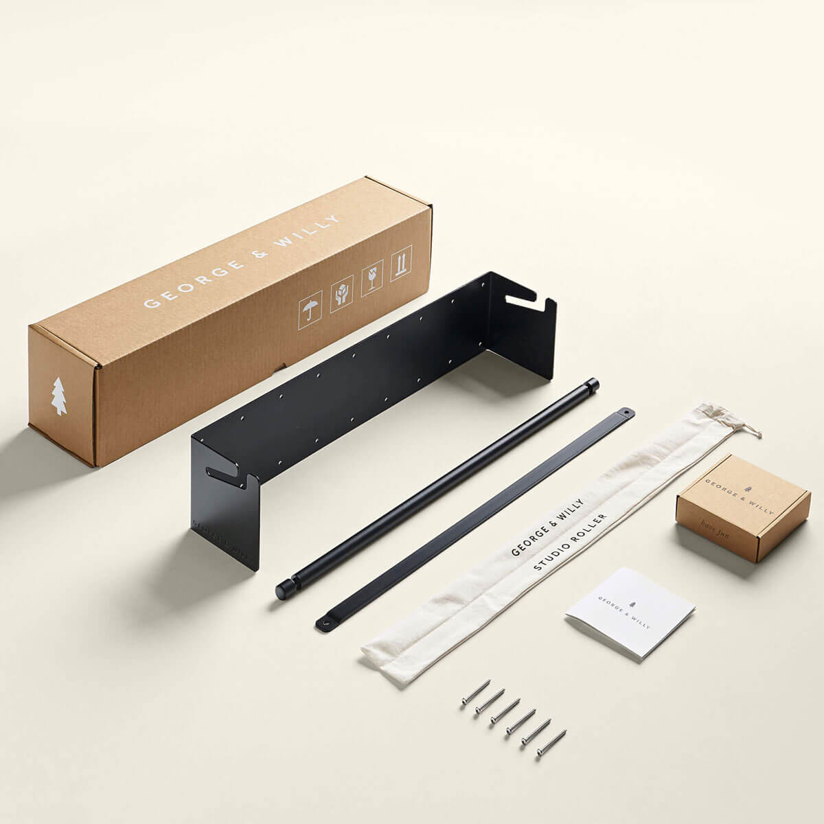 contents of an unassembled studio roller laid out neatly