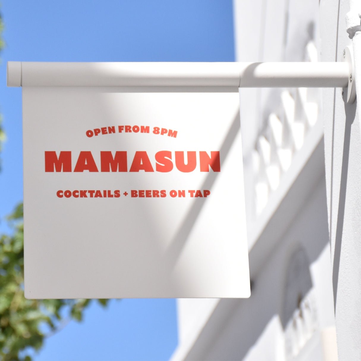 white wall-mounted flag business sign with "mamasun" logo branding on it