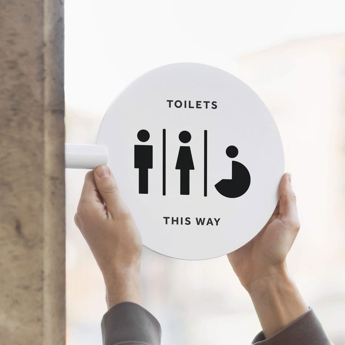 two hands holding the circle sign featuring toilet symbols